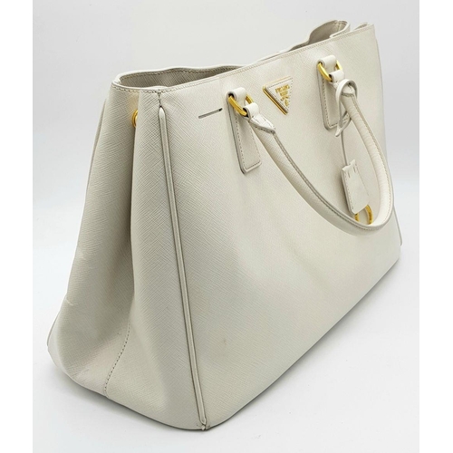 57 - A Prada Cream Galleria Handbag. Saffiano leather exterior with gold-toned hardware, two rolled handl... 