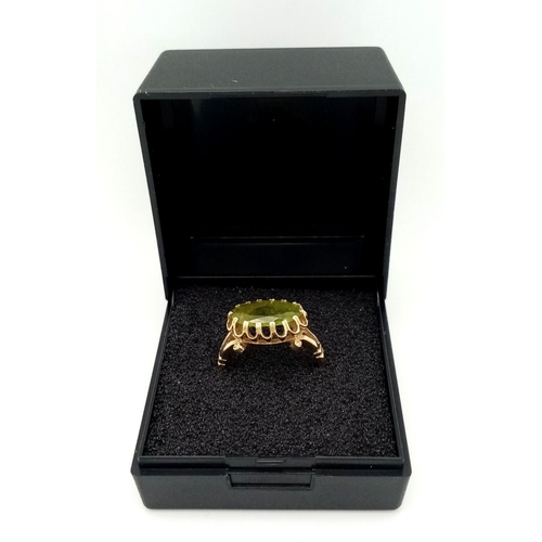 70 - Impressive and elegant 14 carat GOLD RING, having a long Oval Cut PERIDOT GEMSTONE in an Attractive ... 