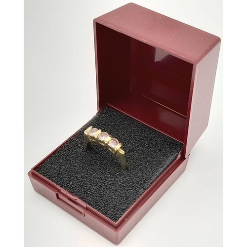 91 - A Sophisticated 9 carat GOLD and PINK SPINEL RING. Having 3 x  round cut PINK SPINEL mounted  to top... 