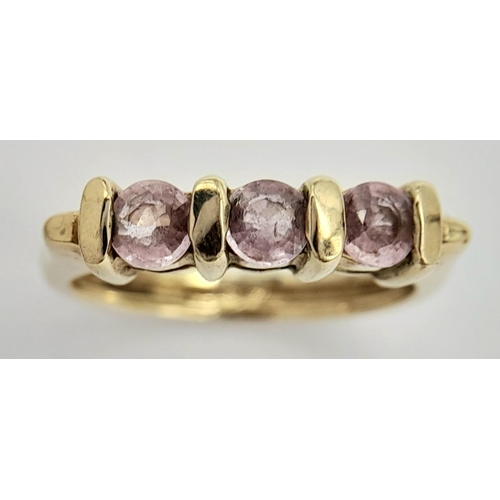 91 - A Sophisticated 9 carat GOLD and PINK SPINEL RING. Having 3 x  round cut PINK SPINEL mounted  to top... 