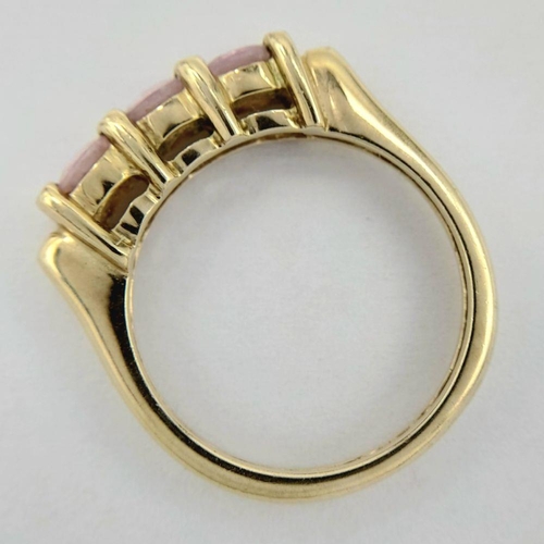 91 - A Sophisticated 9 carat GOLD and PINK SPINEL RING. Having 3 x  round cut PINK SPINEL mounted  to top... 