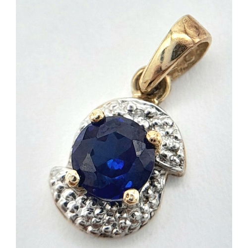 1538 - A 9K YELLOW GOLD DIAMOND & SAPPHIRE PENDANT 0.7G TOTAL WEIGHT, 0.5CM X 0.7CM.

ref: SC 1034