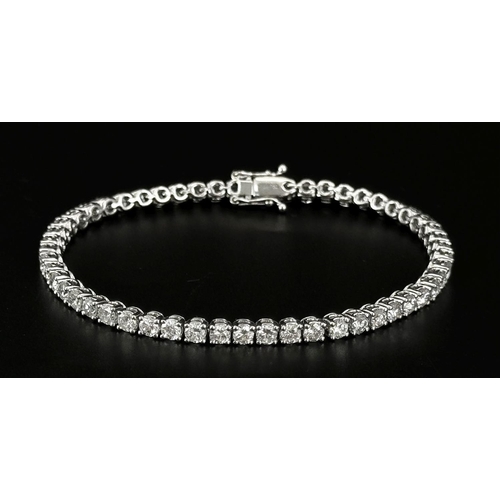 4 - AN 18K WHITE GOLD DIAMOND SET TENNIS BRACELET -5CTW APPROX OF BRILLIANT ROUND CUT DIAMONDS. 12.8G TO... 