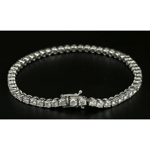 4 - AN 18K WHITE GOLD DIAMOND SET TENNIS BRACELET -5CTW APPROX OF BRILLIANT ROUND CUT DIAMONDS. 12.8G TO... 