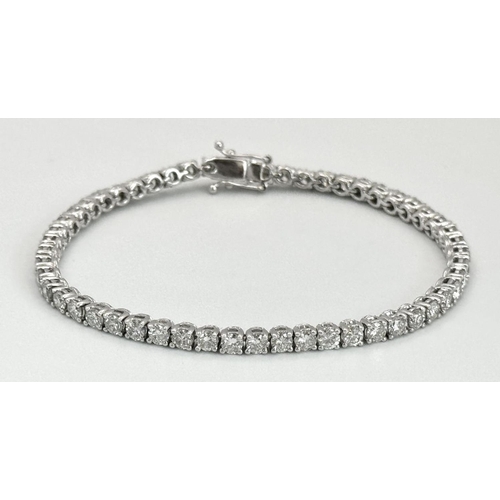 4 - AN 18K WHITE GOLD DIAMOND SET TENNIS BRACELET -5CTW APPROX OF BRILLIANT ROUND CUT DIAMONDS. 12.8G TO... 