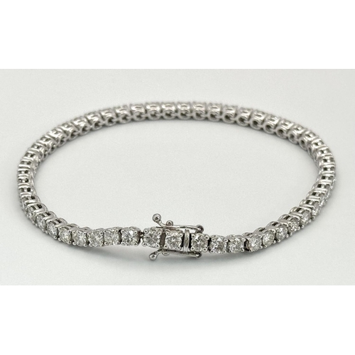 4 - AN 18K WHITE GOLD DIAMOND SET TENNIS BRACELET -5CTW APPROX OF BRILLIANT ROUND CUT DIAMONDS. 12.8G TO... 