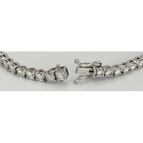 4 - AN 18K WHITE GOLD DIAMOND SET TENNIS BRACELET -5CTW APPROX OF BRILLIANT ROUND CUT DIAMONDS. 12.8G TO... 