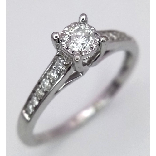 1340 - A 9K white gold diamond ring with diamond set shoulders, size N, (dia:0.25ct). Total weight 2g. Ref ... 