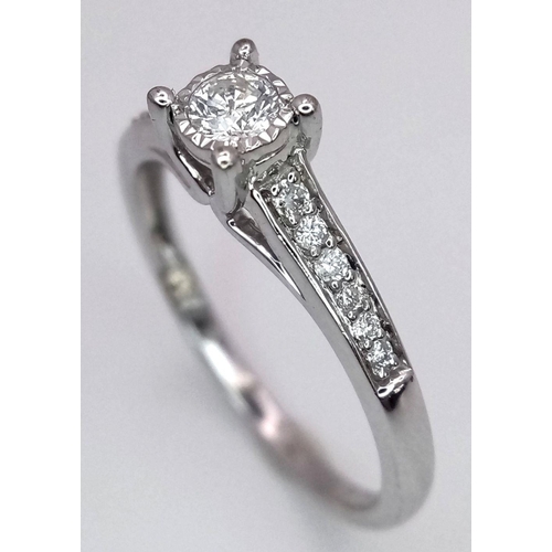 1340 - A 9K white gold diamond ring with diamond set shoulders, size N, (dia:0.25ct). Total weight 2g. Ref ... 