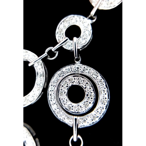 40 - A 14K White Gold and Diamond Galaxy-Esque Pendant and three strand necklace. A hanging pendant with ... 