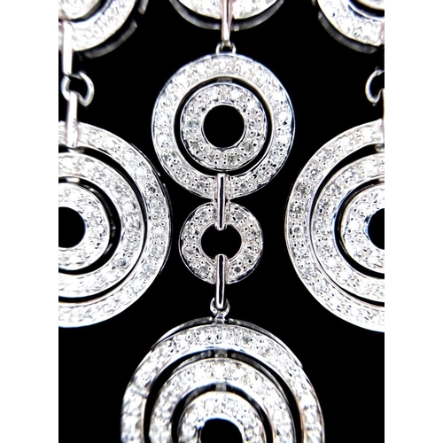 40 - A 14K White Gold and Diamond Galaxy-Esque Pendant and three strand necklace. A hanging pendant with ... 