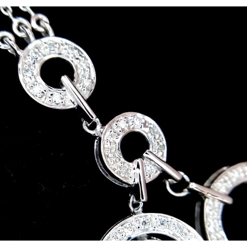 40 - A 14K White Gold and Diamond Galaxy-Esque Pendant and three strand necklace. A hanging pendant with ... 