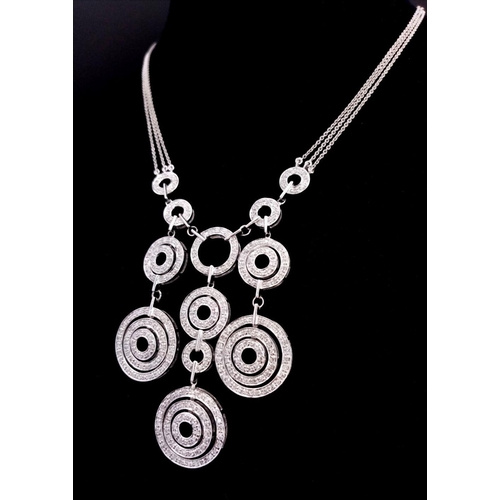 40 - A 14K White Gold and Diamond Galaxy-Esque Pendant and three strand necklace. A hanging pendant with ... 
