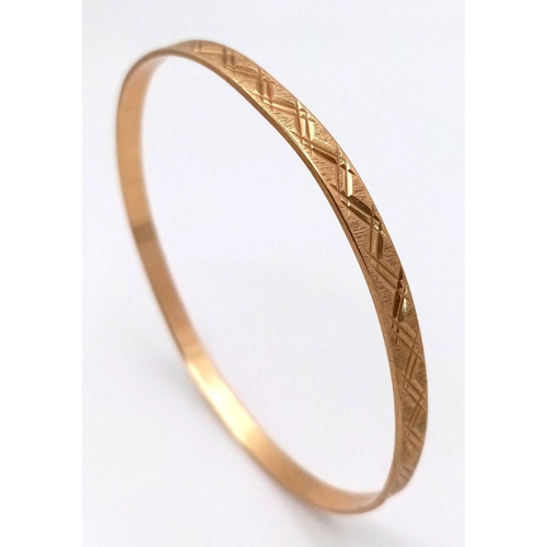 116 - A 9K yellow gold engraved bangle, 9.5g total weight, 6.5cm diameter. Ref: SH1678I