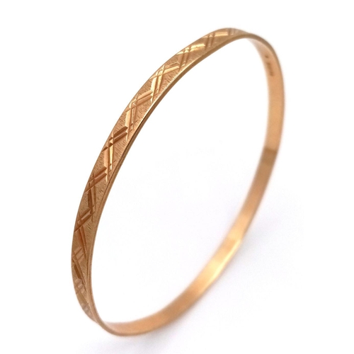 116 - A 9K yellow gold engraved bangle, 9.5g total weight, 6.5cm diameter. Ref: SH1678I