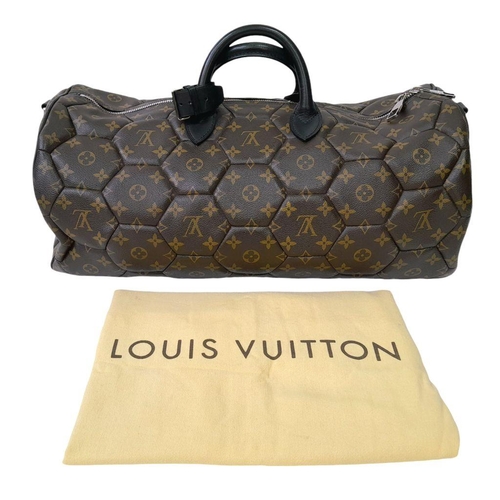 38 - A Louis Vuitton Monogram Hexagone Keepall Bandouliere Bag. Monogram-coated canvas exterior with hexa... 