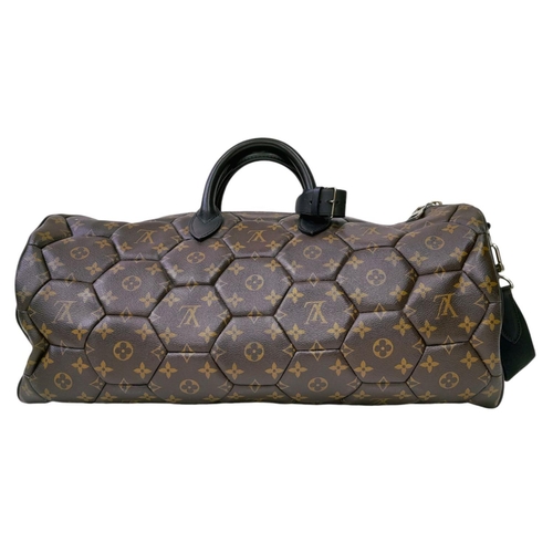 38 - A Louis Vuitton Monogram Hexagone Keepall Bandouliere Bag. Monogram-coated canvas exterior with hexa... 