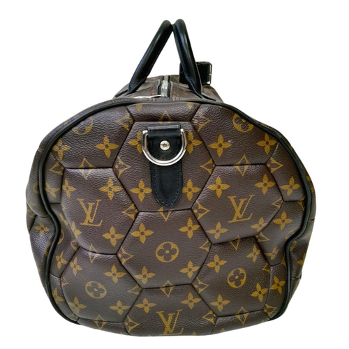 38 - A Louis Vuitton Monogram Hexagone Keepall Bandouliere Bag. Monogram-coated canvas exterior with hexa... 