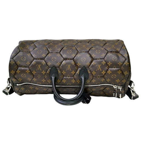 38 - A Louis Vuitton Monogram Hexagone Keepall Bandouliere Bag. Monogram-coated canvas exterior with hexa... 