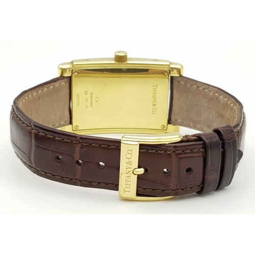 55 - A Tiffany and Co. 18K Gold Grand Resonator Ladies Watch. Brown leather strap with 18K gold clasp. 18... 