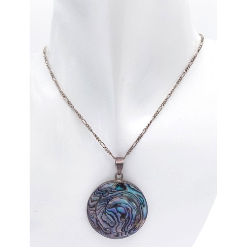 616 - An ABALONE PENDANT in Circular form, set in SILVER and Mounted on a fine SILVER FIGARO LINK NECKLACE... 