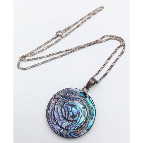 616 - An ABALONE PENDANT in Circular form, set in SILVER and Mounted on a fine SILVER FIGARO LINK NECKLACE... 