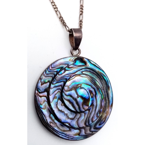 616 - An ABALONE PENDANT in Circular form, set in SILVER and Mounted on a fine SILVER FIGARO LINK NECKLACE... 