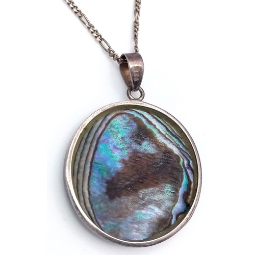 616 - An ABALONE PENDANT in Circular form, set in SILVER and Mounted on a fine SILVER FIGARO LINK NECKLACE... 