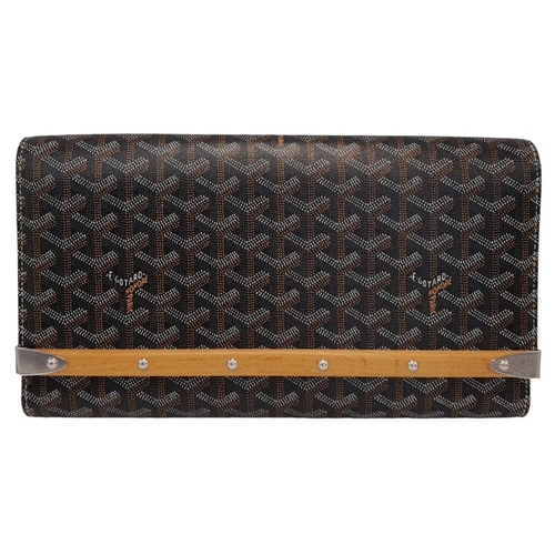 87 - A Goyard Honore Clutch. Coated canvas and leather exterior with silver-toned hardware and a button s... 