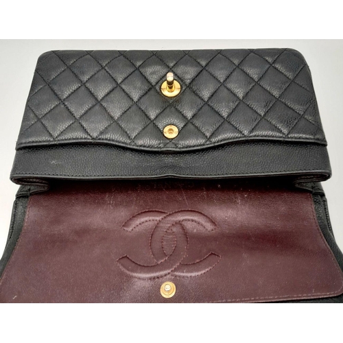 65 - A Chanel Black Quilted Classic Flap Bag. Leather exterior with gold-toned hardware and a flap closur... 