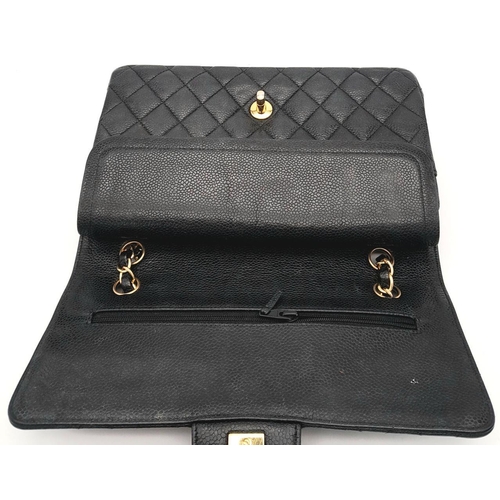 65 - A Chanel Black Quilted Classic Flap Bag. Leather exterior with gold-toned hardware and a flap closur... 