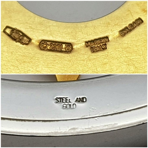 51 - A Bulgari Steel and 18K Yellow Gold Sun Pendant. 4.5cm diameter.  Textile necklace. Comes with origi... 