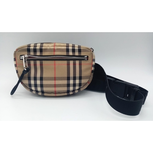 227 - A Burberry canvas bum bag (fanny pack), Silver top zip plus additional zipped pouch to front, adjust... 