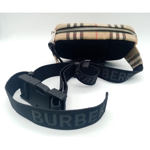 227 - A Burberry canvas bum bag (fanny pack), Silver top zip plus additional zipped pouch to front, adjust... 