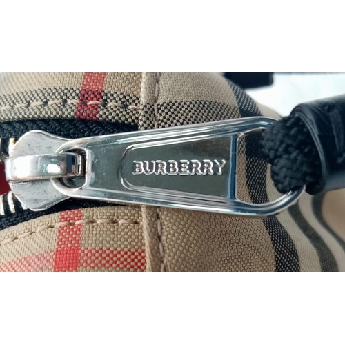 227 - A Burberry canvas bum bag (fanny pack), Silver top zip plus additional zipped pouch to front, adjust... 