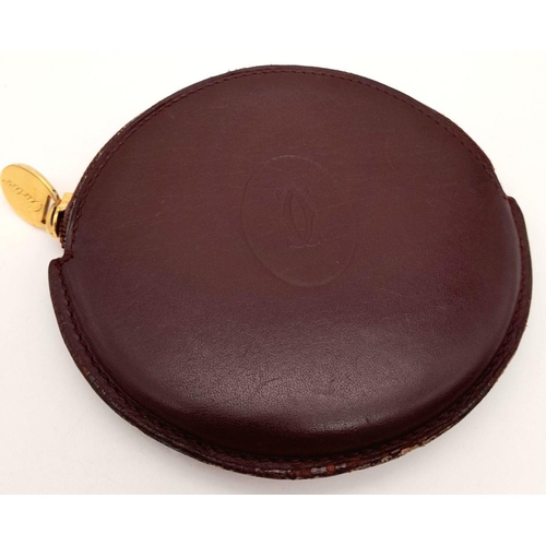 234 - A Burgundy Cartier Purse. Leather exterior, zipper closure, gold-tone hardware and a open side pocke... 