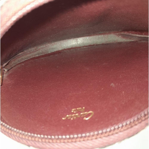 234 - A Burgundy Cartier Purse. Leather exterior, zipper closure, gold-tone hardware and a open side pocke... 