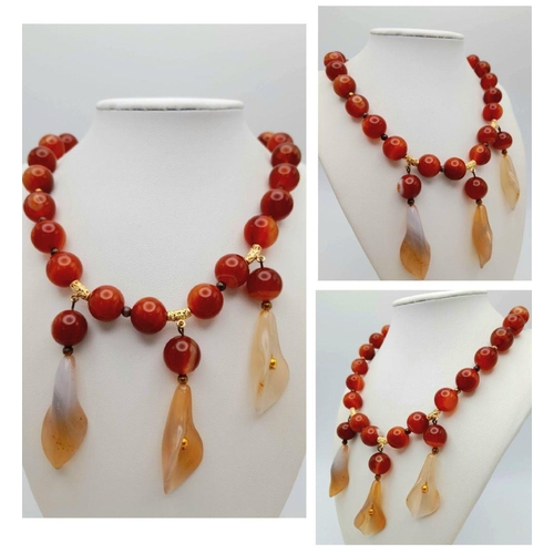 140 - A vintage carnelian necklace and earrings set with carved Arum lilies pendants (often cale Cala lili... 