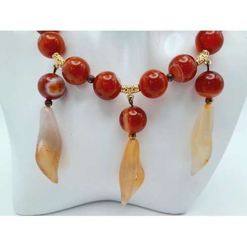 140 - A vintage carnelian necklace and earrings set with carved Arum lilies pendants (often cale Cala lili... 