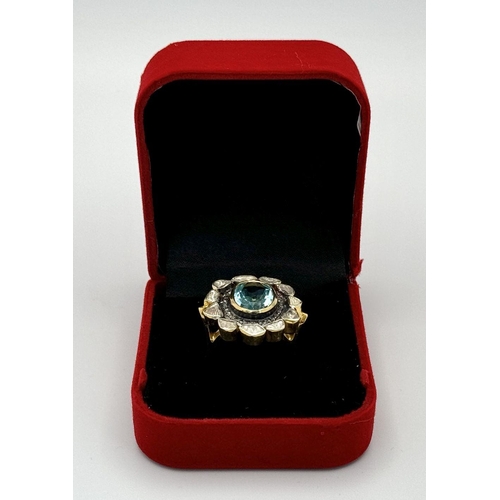 142 - A Blue Topaz and Diamond Ring. A central oval cut sky blue 3ct topaz with a twin diamond surround. O... 