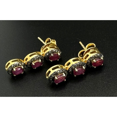 163 - A Ruby and Diamond Tennis Necklace and Drop Earrings Set. Oval cut deep red rubies each with an old ... 