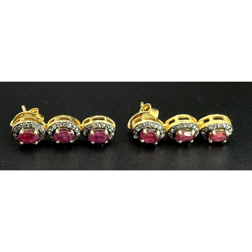 163 - A Ruby and Diamond Tennis Necklace and Drop Earrings Set. Oval cut deep red rubies each with an old ... 