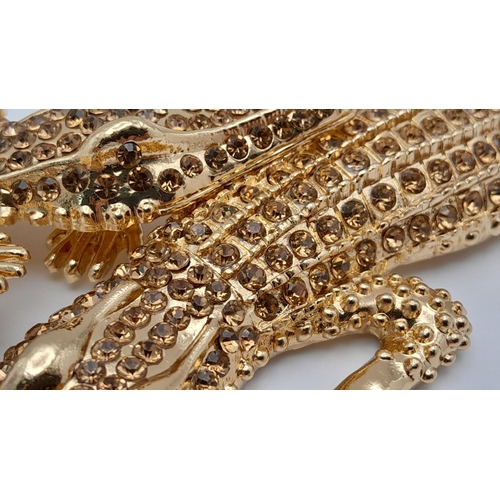 168 - A statement necklace with two gold plated overlapping crocodiles covered with yellow diamante. For t... 