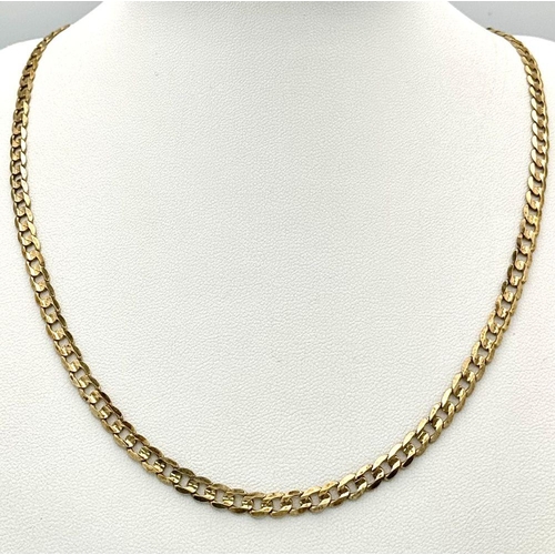 17 - A 9K Yellow Gold Flat Curb Link Chain. 44cm length. 10.9g weight.