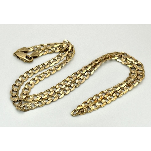 17 - A 9K Yellow Gold Flat Curb Link Chain. 44cm length. 10.9g weight.