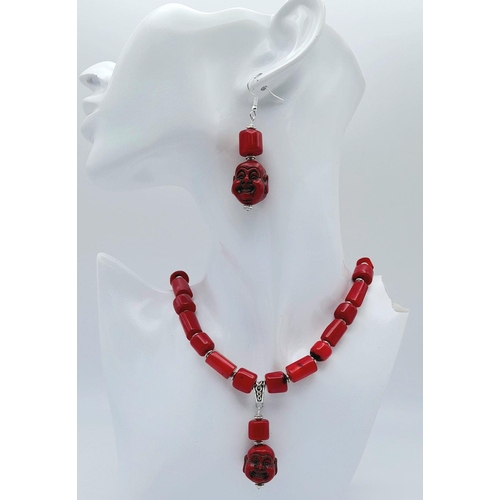 210 - A substantial, chunky, Pacific red coral necklace and earrings set with smiling Buddha head pendants... 