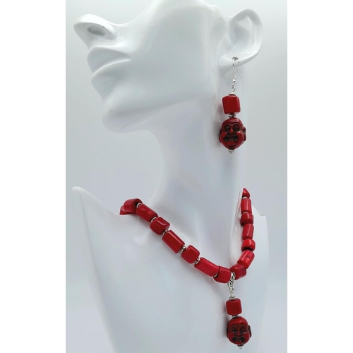 210 - A substantial, chunky, Pacific red coral necklace and earrings set with smiling Buddha head pendants... 