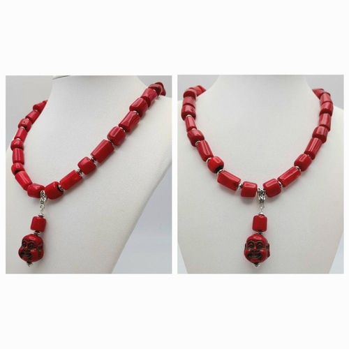 210 - A substantial, chunky, Pacific red coral necklace and earrings set with smiling Buddha head pendants... 