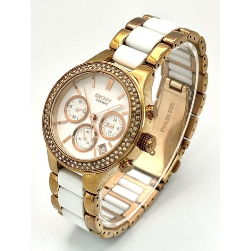 231 - A rose gold plated, Ceramic DKNY Chronometer watch, 38 mm case, bezel with cubic zirconia, white dia... 