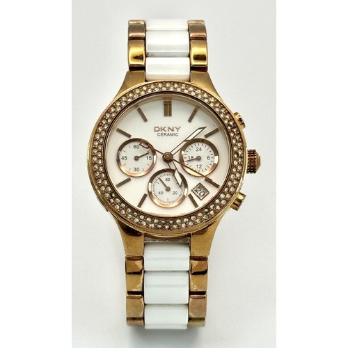 231 - A rose gold plated, Ceramic DKNY Chronometer watch, 38 mm case, bezel with cubic zirconia, white dia... 